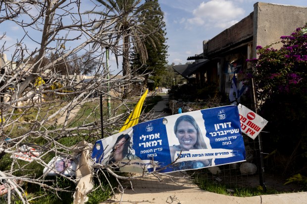 A poster with photos of hostages Doron Steinbrecher and Emily Damari who Hamas said is to be releasing today is seen in the youth neighborhood were they were kidnaped during the deadly Oct 7 Hamas attack, after the first phase of a ceasefire agreement began between Israel and Hamas on Jan. 19, 2025, in Southern Israel, Israel. (Amir Levy/Getty)