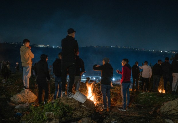 Palestinians gather overlooking Ofer prison, ahead of the prisoners' release following the ceasefire agreement started between Israel and Hamas, in Beitunia, West Bank on Jan. 19, 2025. (Laura Boushnak/The New York Times)