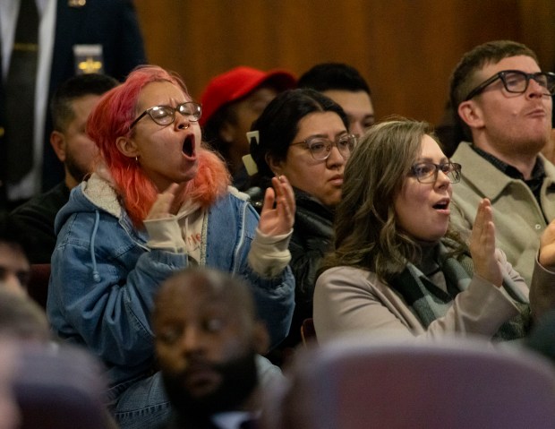 Protesters clap in support of Chicago's sanctuary city status during public comment of a City Council meeting, Jan. 15, 2025, at City Hall. (Brian Cassella/Chicago Tribune)