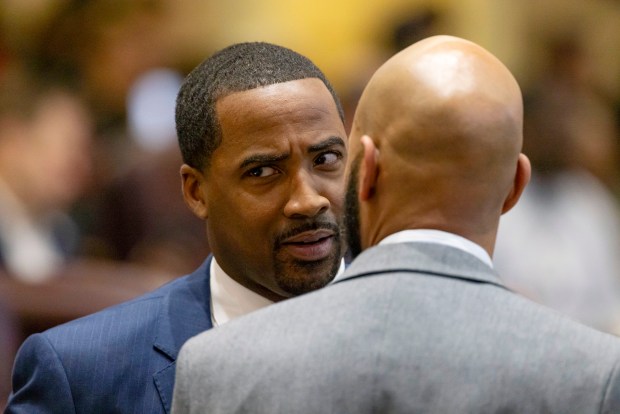 Ald. William Hall, 6th, left, and Ald. Lamont Robinson, 4th, talk during a City Council meeting Jan. 15, 2025, at City Hall. (Brian Cassella/Chicago Tribune)