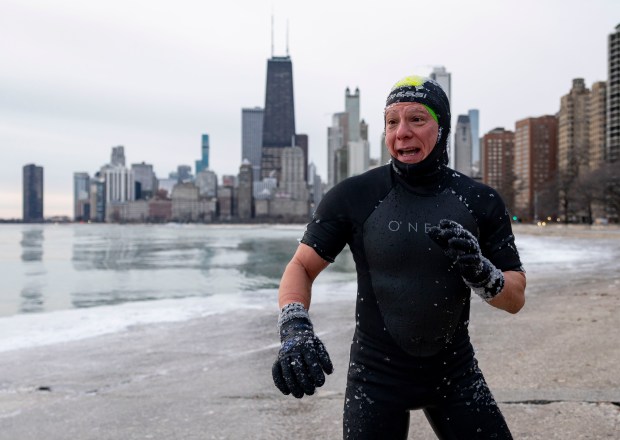 Steve Hernan, a veteran open water swimmer, emerges from Lake Michigan on Sunday, Jan. 19, 2025, with temperatures in the single digits around sunrise. (Brian Cassella/Chicago Tribune)