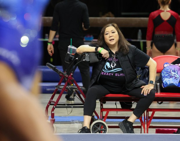 Legacy Elite Gymnastics coach Jiani Wu watches a gymnast compete during the Illinois State Level 10 Meet at Redbird Arena on March 17, 2023, in Normal, Illinois. (Stacey Wescott/Chicago Tribune)