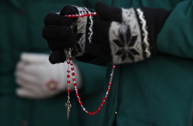 Sister Pat Murphy, 95, left, and Sister Joann Persch pray during a service for immigrants outside of Immigration and Customs Enforcement's Broadview Service Staging facility early morning on Dec. 6, 2024. (Stacey Wescott/Chicago Tribune)