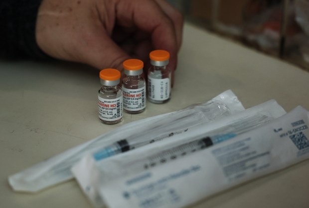 Karen Bigg, a harm reductionist for the Chicago Recovery Alliance, shows the contents of a kit for administering naloxone, aka Narcan, for drug overdoses while working in a mobile outreach van at Humboldt Park, July 25, 2023, in Chicago. (John J. Kim/Chicago Tribune)