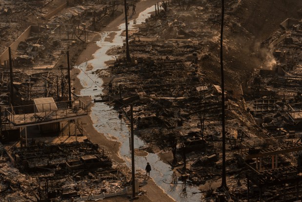 A person walks amid the destruction left behind by the Palisades Fire in the Pacific Palisades neighborhood of Los Angeles, Jan. 9, 2025. (Jae C. Hong/AP)