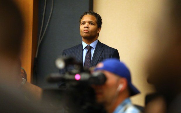 Former Congressman Jesse Jackson Jr. listens to a press conference given by his father, Jesse Jackson Sr., and then-presidential candidate Pete Buttigieg at the Rainbow/PUSH Coalition convention on July 2, 2019 in Chicago. (Stacey Wescott/Chicago Tribune)