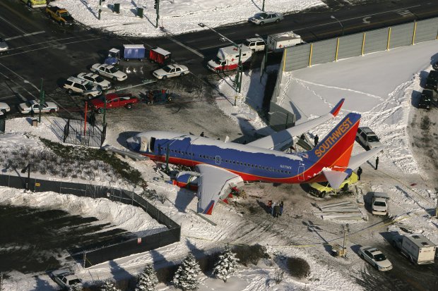 A Southwest Airlines Boeing 737 rests in the middle of Central Avenue near Midway Airport on Dec. 9, 2005. The jetliner, trying to land in heavy snow, slid off the runway the previous day, crashed through a boundary fence, and slid out into the street, hitting one car and pinning another beneath it. A child in one of the vehicles was killed. (Phil Velasquez/Chicago Tribune)