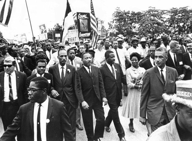 The Rev. Martin Luther King Jr., center, with Al Raby, left, convener of the Coordinating Council of Community Organizations, leads a march to protest the segregation policies of schools Superintendent Benjamin Willis on July 26, 1965, that began in Grant Park. (Steve Lasker/Chicago's American)