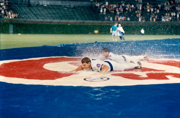 What better way to wait out a rain delay than by working on your sliding? At least that's what Jody Davis, foreground, and Les Lanacaster did during a delay at Wrigley Field during the first scheduled night game on Aug. 8, 1988. (Ovie Carter/Chicago Tribune)