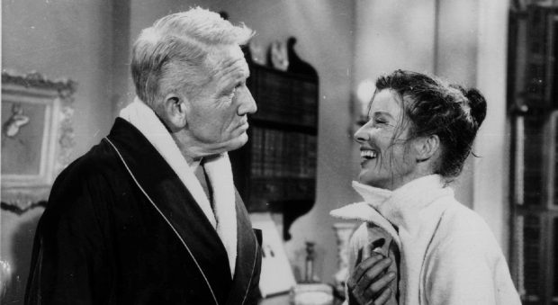 Katharine Hepburn (right) and Spencer Tracy talk between scenes on the set of "The Desk Set." (AP)