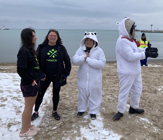 Julie Ivic, left, and April Work of American Place casino are interviewed by a "polar bear." (Steve Sadin/For the Lake County News-Sun)