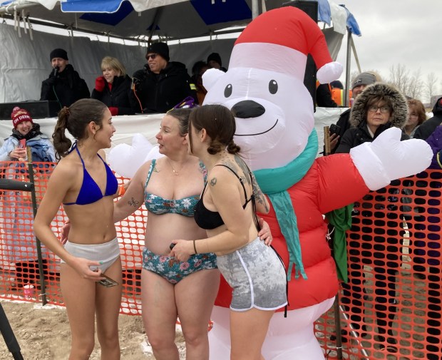 Clad for an Aug. day at the beach, these Zion women talk after their venture into Lake Michigan. (Steve Sadin/For the Lake County News-Sun)