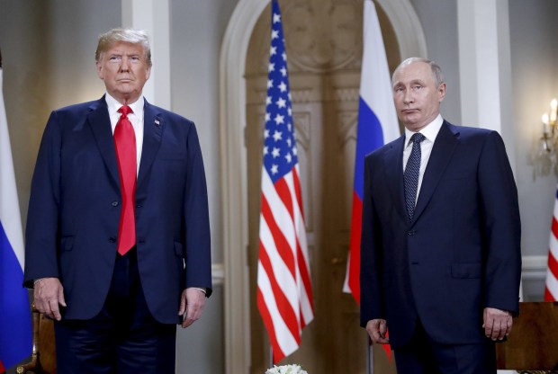 U.S. President Donald Trump, left, and Russian President Vladimir Putin, right, stand together before the start of their meeting at the Presidential Palace in Helsinki, Finland, Monday, July 16, 2018. (AP Photo/Pablo Martinez Monsivais)