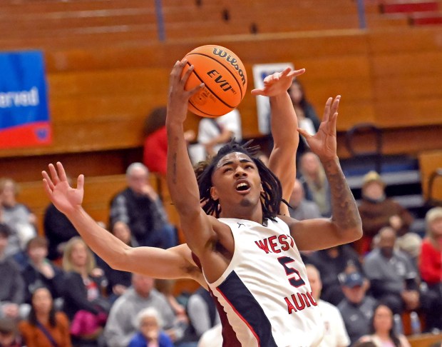 West Aurora's Terrence Smith scores a layup after snagging an offensive rebound. West Aurora defeated Brother Rice 56-51 in a boys basketball game Saturday, Feb. 8, 2025, in Aurora, Illinois. (Jon Langham/for the Beacon-News)