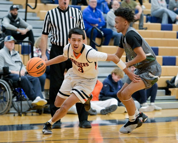 Oswego's Ethan Vahl (3) drives around Plainfield Central's Zion Finch (3) during the Class 4A Waubonsie Valley Regional quarterfinal in Oswego on Monday, Feb. 24, 2025. (Mark Black / for the Beacon-News)