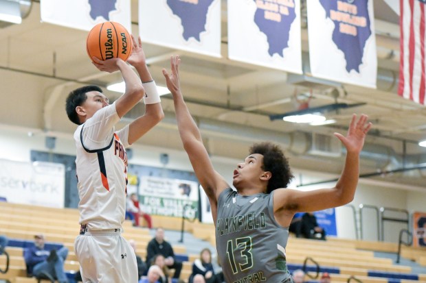 Oswego's Ethan Vahl (3) takes a shot over Plainfield Central's Phoenix Jones (13) during the Class 4A Waubonsie Valley Regional quarterfinal in Oswego on Monday, Feb. 24, 2025. (Mark Black / for the Beacon-News)