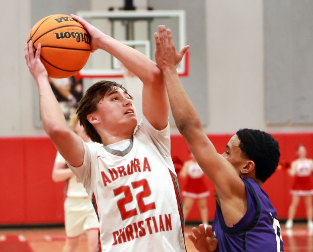 Aurora Christian's Jacob Baumann, left, shoots for two as Plano's Amari Bryant, right, defends during the boys basketball game in Aurora on Friday, Feb. 21, 2025. (James C. Svehla / for the Beacon-News)