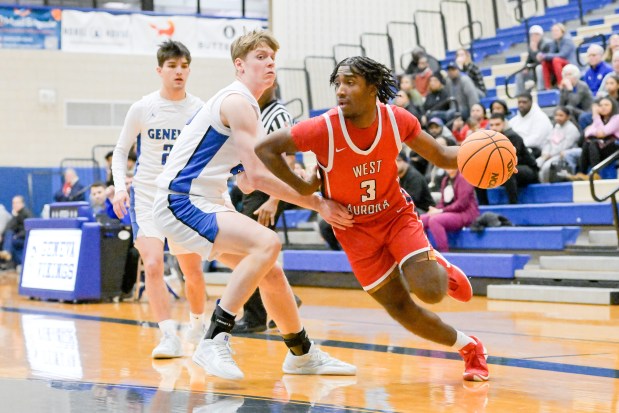 West Aurora's Jaden Edwards (3) drives around Geneva's Hudson Kirby (25) during a game in Geneva on Monday, Jan. 20, 2025. (Mark Black / for the Beacon-News)