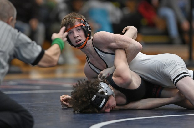 St. Charles East's Declan Sons works to turn South Elgin's Nickolas Dilalio for the championship at 113 pounds during Saturday's IHSA Class 3A Conant Sectional, Feb. 15, 2025. (Brian O'Mahoney for the The Beacon-News)