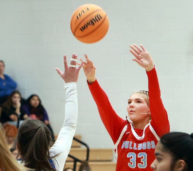 Batavia's Natalie Warner shoot for three as St. Charles North defends during the girls basketball game in St. Charles on Tuesday, Feb. 4, 2025. (James C. Svehla / for the Beacon-News)