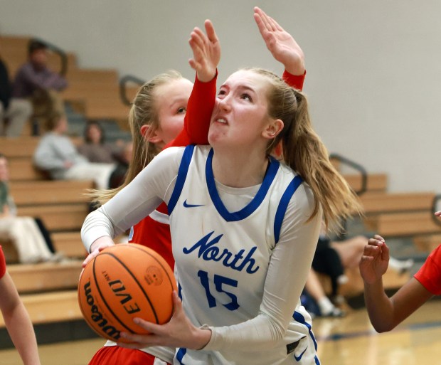 St. Charles North's Mia Nowak goes for the basket as Batavia's Ali Thomas defends during the girls basketball game in St. Charles on Tuesday, Feb. 4, 2025. (James C. Svehla / for the Beacon-News)