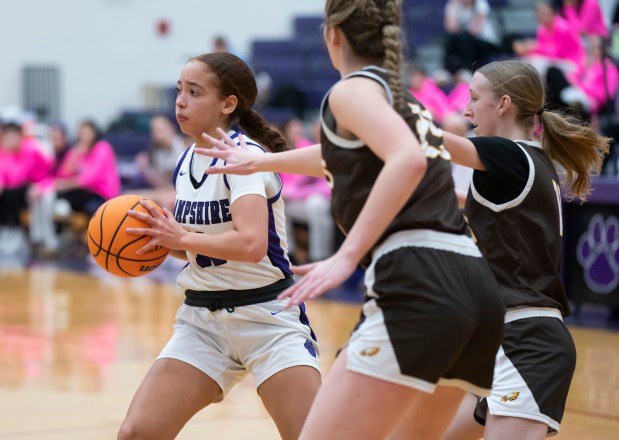 Hampshire's Mikala Amegasse looks to pass under pressure from Jacobs' Olivia Schuster and Mallory Fessler, right, during their game at Hampshire High School on Wednesday, Feb., 5, 2025. Hampshire defeated Jacobs 39-37. (Ryan Rayburn/for the Aurora Beacon News)