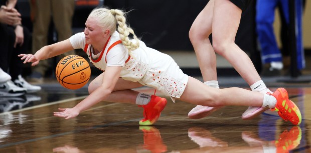 St. Charles East's Addison Schilb (13) dives for a loose ball in the second quarter during a Class 4A St. Charles East Sectional semifinal game against Glenbard West in St. Charles on Tuesday, Feb. 25, 2025.H. Rick Bamman / For the Beacon-News