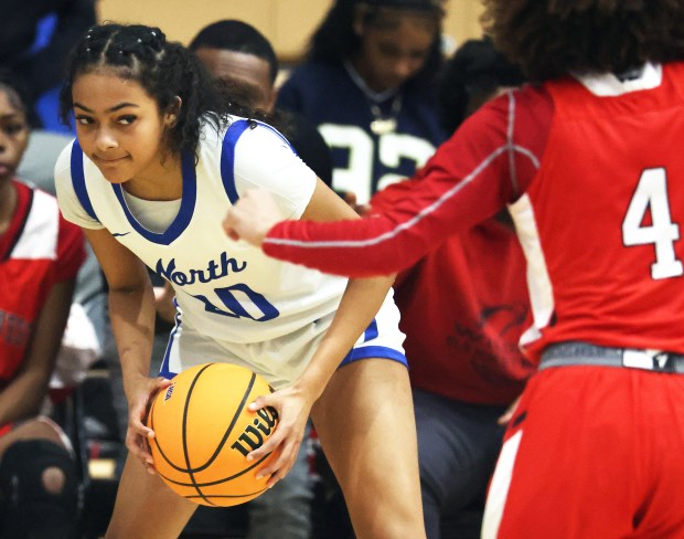 St. Charles North's Sydney Johnson (20) glances to an open teammate past Proviso West defender Makie Jackson in the first quarter during a Class 4A St. Charles North Regional semifinal game in St. Charles on Tuesday, Feb. 18, 2025. Johnson broke school records for points scored and 3-point baskets.H. Rick Bamman / For the Beacon News