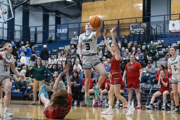 Oswego East's Maggie Lewandowski (3) goes up for a layup against Yorkville during a Southwest Prairie Conference game in Oswego on Tuesday, Feb. 11, 2025. (Troy Stolt / for the Beacon News)