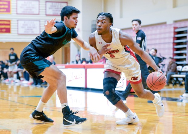 Waubonsee's Christian Meeks (0) drives past Oakton's Aidin Custovic (25) during a game at home in Sugar Grove on Tuesday, Feb. 4, 2025. (Mark Black / for the Beacon-News)