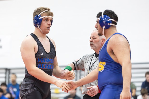 Marmion's Mateusz Nycz shakes hands with Sandburg's Omar Alhmoud after winning their 285 pound match by pin during the Class 3A Yorkville Dual Team Sectional in Yorkville on Tuesday, Feb. 25, 2025. (Troy Stolt / for the Beacon News)