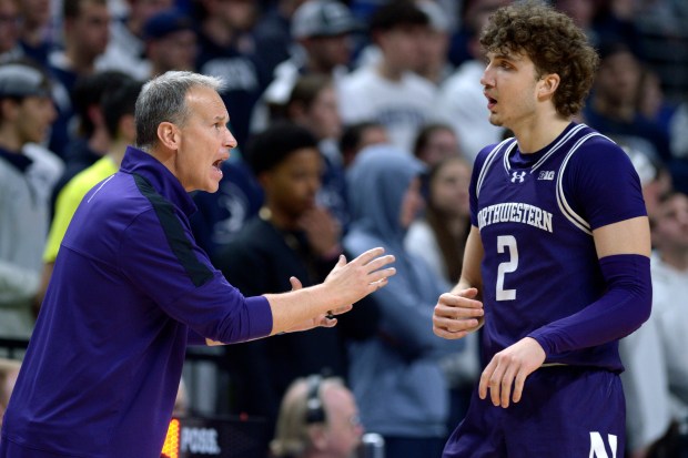 Northwestern head coach Chris Collins,left, gives instructions to Nick Martinelli (2) during the second half of an NCAA college basketball game with Penn State Wednesday, Jan. 10, 2024, in State College, Pa. (AP Photo/Gary M. Baranec)