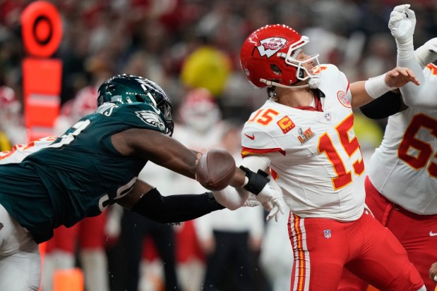 Philadelphia Eagles defensive tackle Milton Williams, left, strips the ball from Kansas City Chiefs quarterback Patrick Mahomes (15) during the second half of the NFL Super Bowl 59 football game, Sunday, Feb. 9, 2025, in New Orleans. (AP Photo/Matt Slocum)