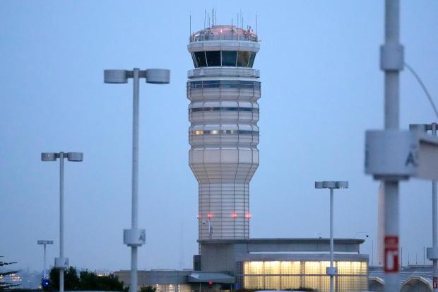 The air traffic control tower at Ronald Reagan Washington National Airport is pictured, Friday, Jan. 31, 2025, in Arlington, Va., near the wreckage of a mid-air collision between a Black Hawk helicopter and an American Airlines jet in the Potomac River. (AP Photo/Alex Brandon)