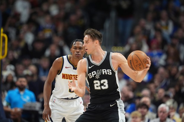 Spurs' Zach Collins goes against the Nuggets' Peyton Watson in the first half on Jan. 3, 2025, in Denver. (AP Photo/David Zalubowski)