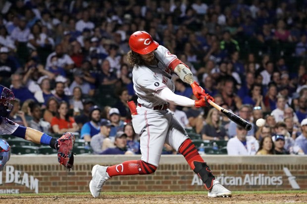 Reds third baseman Jonathan India hits an RBI double in the ninth inning against the Cubs at Wrigley Field on July 27, 2021. (Terrence Antonio James/Chicago Tribune)