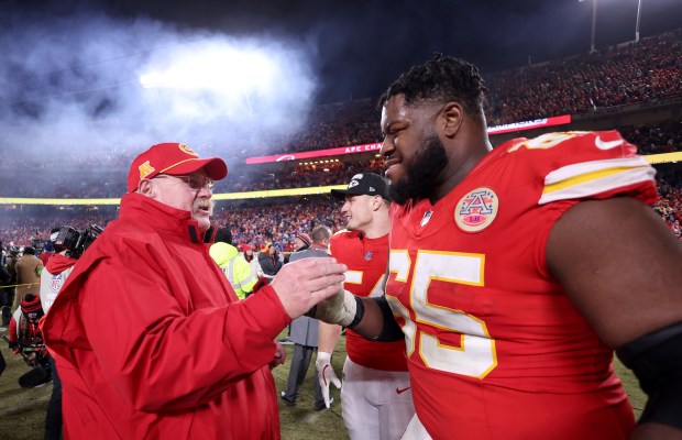 Chiefs coach Andy Reid shakes hands with guard Trey Smith after defeating the Bills in the AFC championship game Jan. 26, 2025, in Kansas City, Mo. (Jamie Squire/Getty Images)