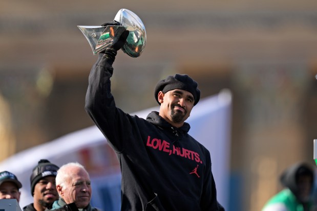 Eagles quarterback Jalen Hurts holds up the Lombardi Trophy as he speaks during the team's Super Bowl celebration Friday, Feb. 14, 2025, in Philadelphia. (AP Photo/Matt Rourke)