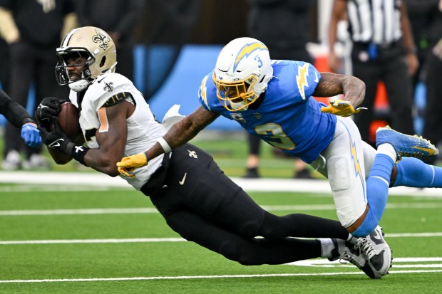 Saints tight end Juwan Johnson hauls in a pass as Chargers safety Derwin James defends Oct. 27, 2024, in Inglewood, Calif. (David Crane/Los Angeles Daily News)