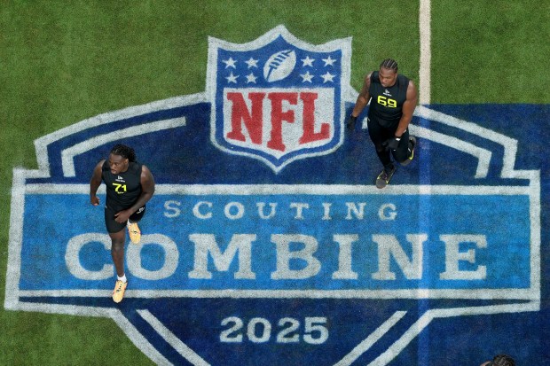 Mississippi defensive lineman Princely Umanmielen and LSU defensive lineman Bradyn Swinson walk between drills at the NFL scouting combine Thursday, Feb. 27, 2025, in Indianapolis. (AP Photo/Charlie Riedel)