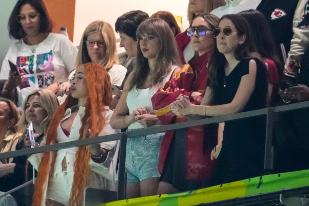 Ice Spice, from left, Taylor Swift, Este Haim and Alana Haim watch the first half of the Super Bowl on Sunday, Feb. 9, 2025, in New Orleans. (AP Photo/Gerald Herbert)