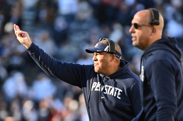 Penn State co-offensive coordinator and running backs coach Ja'Juan Seider, left, and head coach James Franklin react during a game against Rutgers on Nov. 18, 2023, in State College, Pa. (AP Photo/Barry Reeger)