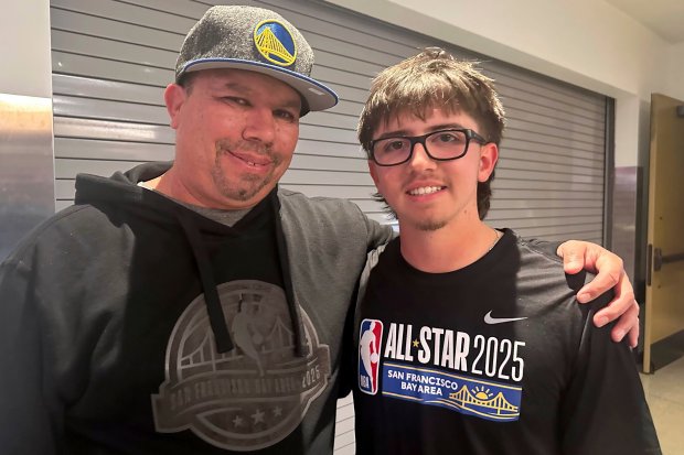 All-Star shooting contest winner Jaren Barajas, right, an 18-year-old college freshman, poses with father Michael after beating Damian Lillard in a 3-point contest to win $100,000 on Sunday, Feb. 16, 2025, in San Francisco. (AP Photo/Janie McCauley)