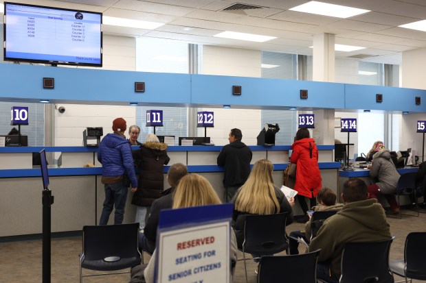 Morton Grove resident Bob Dounis stands at window No.12 to receive a temporary paper version of his driver's license after having it renewed with a REAL ID version at the Chicago North Secretary of State Facility, 5401 N. Elston Ave., on Feb. 20, 2025. (John J. Kim/Chicago Tribune)