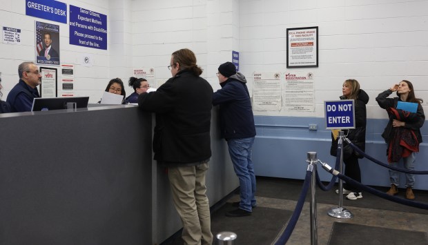 Chicago resident Carmen Mateo, second from right, waits in line to have her driver's license renewed in a Real ID version on Feb. 20, 2025, at the Secretary of State Facility, 5401 N. Elston Ave., in Chicago. (John J. Kim/Chicago Tribune)