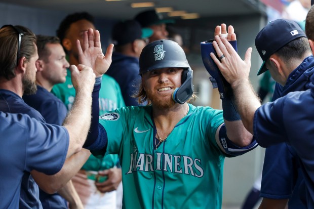 Justin Turner of the Mariners celebrates after scoring against the Mets on Aug. 10, 2024, in Seattle. (Brandon Sloter/Getty Images)