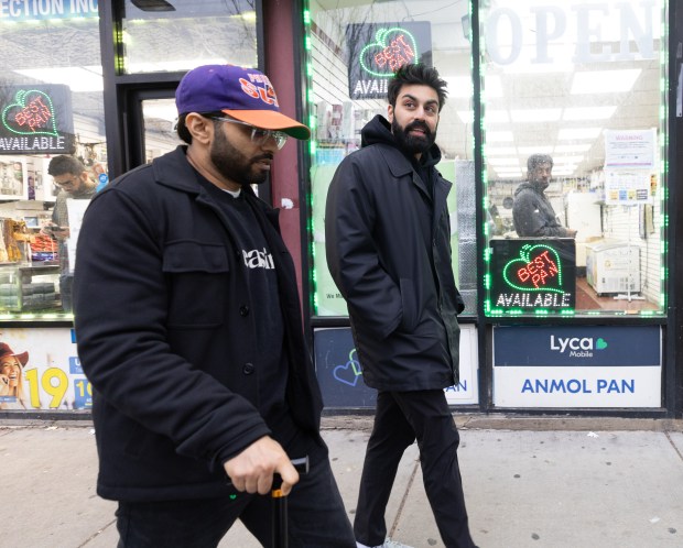 Asif Ali, left, and Saagar Shaikh, stars of Deli Boys walk along the 2500 block of West Devon Avenue to a sweets shop following a dinner at Ali's Nihari & BBQ in the West Ridge neighborhood on March, 31, 2024. (Talia Sprague/for Chicago Tribune)