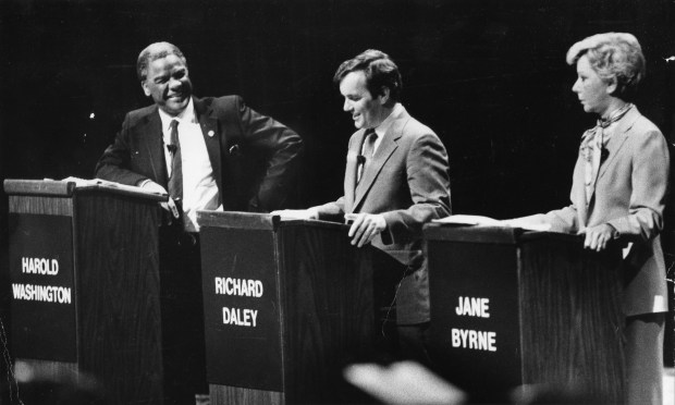 The gladiators, Harold Washington, Richard Daley and Jane Byrne, in the mayoral debate on Monday, Jan. 31, 1983, are "at ease" for a moment after the last question was answered. It was their fourth and final debate. (Anne Cusack/Chicago Tribune)