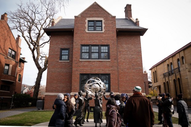 Participants of the Chicago Black Muslim History Tour visit the home being restored as the Elijah Muhammad House Museum in the Kenwood neighborhood on Dec. 6, 2024. (E. Jason Wambsgans/Chicago Tribune)