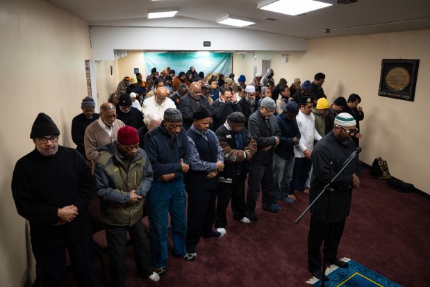 Imam Tariq El-Amin leads Friday prayers at Masjid Al-Taqwa. Participants of the Chicago Black Muslim History Tour stopped at the Calumet Heights mosque for prayer and lunch on Dec. 6, 2024. (E. Jason Wambsgans/Chicago Tribune)